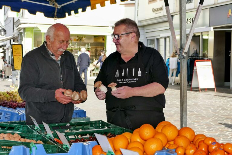 Men Holding Mushrooms